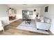 Living room with hardwood floors, neutral decor, wainscotting and sliding glass doors to enclosed porch at 10914 Oakdale Ave, Port Richey, FL 34668