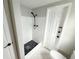 Standing shower with hexagon flooring and sleek shower head at 10914 Oakdale Ave, Port Richey, FL 34668