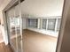 Cozy sunroom featuring lots of windows and carpeted floors at 10914 Oakdale Ave, Port Richey, FL 34668