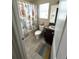 Small bathroom featuring shower with beach-themed curtain and single granite-topped vanity at 11309 Villas On The Green Dr, Riverview, FL 33579