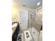 Modern bathroom with double sinks, granite countertops, and a glass-enclosed shower, offering a spa-like experience at 11309 Villas On The Green Dr, Riverview, FL 33579