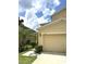 Inviting home featuring a manicured lawn and a two-car garage, perfect for comfortable suburban living at 11309 Villas On The Green Dr, Riverview, FL 33579