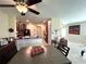 Bright open-concept space features a dining table, kitchen with granite countertops, and a spacious living area at 11309 Villas On The Green Dr, Riverview, FL 33579