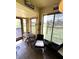 Relaxing sun room with wood-look tile, wicker furnishings, and view of green space at 11309 Villas On The Green Dr, Riverview, FL 33579