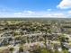 Expansive aerial view showcases a residential area with dense trees and neatly organized home properties at 11422 Brown Bear Ln, Port Richey, FL 34668