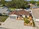 Overhead shot of a home with a large driveway, landscaped yard, and a charming one-story facade at 11422 Brown Bear Ln, Port Richey, FL 34668