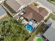 Aerial view showing the house, fenced backyard, pool, and patio area, offering a sense of privacy and space at 11422 Brown Bear Ln, Port Richey, FL 34668