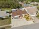 Bird's-eye view of a residential property with a neat lawn, paved driveway, and compact landscaping at 11422 Brown Bear Ln, Port Richey, FL 34668