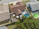 Aerial view of backyard featuring an above ground pool, white umbrellas, and a fenced-in area at 11422 Brown Bear Ln, Port Richey, FL 34668