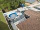Aerial view highlighting the pool, patio area, and overall backyard layout of the property at 11422 Brown Bear Ln, Port Richey, FL 34668