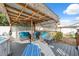 Cozy backyard patio featuring a charming pergola with seating, perfect for outdoor relaxation and entertaining at 11422 Brown Bear Ln, Port Richey, FL 34668