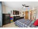 Spacious bedroom featuring neutral walls, a ceiling fan, and an ensuite bathroom for convenience at 11422 Brown Bear Ln, Port Richey, FL 34668