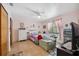 Bedroom features pink walls, a ceiling fan, and a chair for relaxation at 11422 Brown Bear Ln, Port Richey, FL 34668