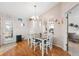 Cozy dining area with hardwood floors, a modern table setting, and a stylish chandelier at 11422 Brown Bear Ln, Port Richey, FL 34668