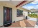 Inviting front entrance with a tiled porch and a decorative glass door at 11422 Brown Bear Ln, Port Richey, FL 34668