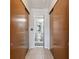 Hallway with closet space leading to a bathroom with a clean, modern aesthetic at 11422 Brown Bear Ln, Port Richey, FL 34668