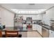 Well-lit kitchen featuring white cabinets, a skylight, stainless steel appliances, and granite countertops at 11422 Brown Bear Ln, Port Richey, FL 34668