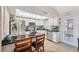Bright kitchen boasts white cabinets, stainless steel appliances, subway tile backsplash, and a sunlit skylight at 11422 Brown Bear Ln, Port Richey, FL 34668