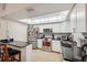 Sunlit kitchen featuring white cabinets, a skylight, stainless steel appliances, and granite countertops at 11422 Brown Bear Ln, Port Richey, FL 34668
