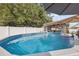 Refreshing above-ground pool surrounded by well-maintained landscaping at 11422 Brown Bear Ln, Port Richey, FL 34668