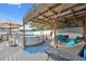 Inviting above-ground pool and deck area with a pergola, offering a perfect outdoor oasis for relaxation and fun at 11422 Brown Bear Ln, Port Richey, FL 34668
