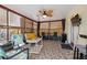 Relaxing sunroom with comfortable seating, tile floor, and backyard views at 11422 Brown Bear Ln, Port Richey, FL 34668