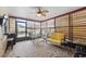 Inviting sunroom with tiled floor, ceiling fan, and backyard access at 11422 Brown Bear Ln, Port Richey, FL 34668