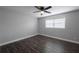 Bedroom with grey walls, hardwood floors, a ceiling fan, and a window with horizontal blinds at 123 Jeffrey Dr, Brandon, FL 33511