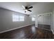 Spacious bedroom featuring a ceiling fan, mirrored closet doors, and large window for natural light at 123 Jeffrey Dr, Brandon, FL 33511