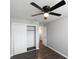 Bedroom with closet, fan, grey walls, hardwood floors, and a view into the hallway at 123 Jeffrey Dr, Brandon, FL 33511