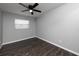 Bedroom with grey walls, hardwood floors, a ceiling fan, and a window with horizontal blinds at 123 Jeffrey Dr, Brandon, FL 33511