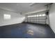 Spacious garage with blue floor, automatic door, and great natural light at 123 Jeffrey Dr, Brandon, FL 33511