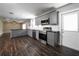 Renovated kitchen with stainless steel appliances, gray cabinets, and a breakfast bar adjacent to the living area at 123 Jeffrey Dr, Brandon, FL 33511