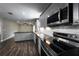 Bright updated kitchen featuring stainless steel appliances, stylish gray cabinetry, and modern lighting fixtures at 123 Jeffrey Dr, Brandon, FL 33511