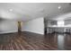 Open concept living room showcasing hardwood floors, fresh paint, recessed lighting, and view into the kitchen at 123 Jeffrey Dr, Brandon, FL 33511