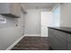 Utility room featuring gray cabinets and hardwood floors at 123 Jeffrey Dr, Brandon, FL 33511