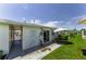 Home featuring a well-maintained lawn, an air conditioner, and a sliding glass door at 12400 Park Blvd # 311, Seminole, FL 33772