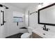 Updated bathroom featuring black hardware and black and white tile at 12400 Park Blvd # 311, Seminole, FL 33772