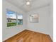 Inviting bedroom with ceiling fan, hardwood floors, and multiple windows offering natural light and outdoor views at 12400 Park Blvd # 311, Seminole, FL 33772
