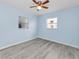Bright bedroom with ceiling fan and two windows with lots of natural light and wood-look floors at 12400 Park Blvd # 311, Seminole, FL 33772