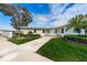 Well-manicured exterior with lush lawn, palm tree, and an American flag at 12400 Park Blvd # 311, Seminole, FL 33772