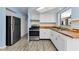 Spacious kitchen featuring white cabinets, butcher block countertops, and modern appliances at 12400 Park Blvd # 311, Seminole, FL 33772