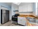 Modern kitchen with white cabinets, butcher block countertops, and updated appliances at 12400 Park Blvd # 311, Seminole, FL 33772