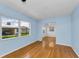 Bright living room with hardwood floors, light blue walls, and a large window at 12400 Park Blvd # 311, Seminole, FL 33772