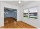 Spacious living room with hardwood floors, large windows, and an open doorway to the adjacent blue room at 12400 Park Blvd # 311, Seminole, FL 33772