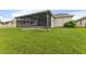 The backyard boasts a screened-in porch and a well-maintained lawn at 13334 Palmera Vista Dr, Riverview, FL 33579