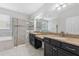 Primary bathroom featuring dual sink vanity, a soaking tub, and a glass enclosed shower at 13334 Palmera Vista Dr, Riverview, FL 33579