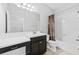 Well-lit bathroom features a shower-tub combo and black vanity with white countertop at 13334 Palmera Vista Dr, Riverview, FL 33579
