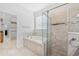 Modern bathroom with soaking tub, glass shower, and walk in closet for a luxurious at-home spa experience at 13334 Palmera Vista Dr, Riverview, FL 33579