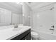 A bathroom with modern fixtures including a tub and a black vanity with white countertop at 13334 Palmera Vista Dr, Riverview, FL 33579